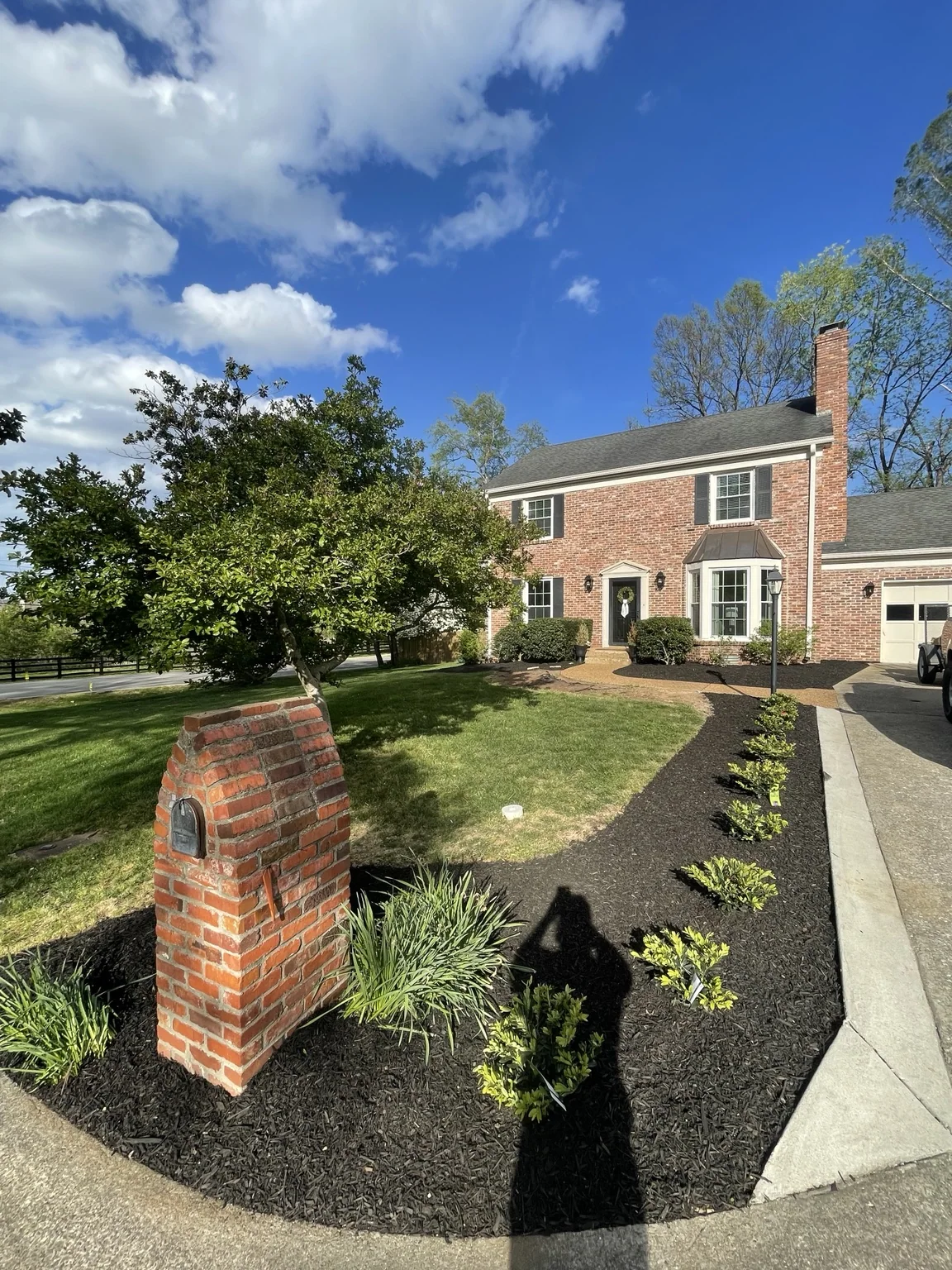 Completed residential landscape renovation with new plantings and fresh mulch