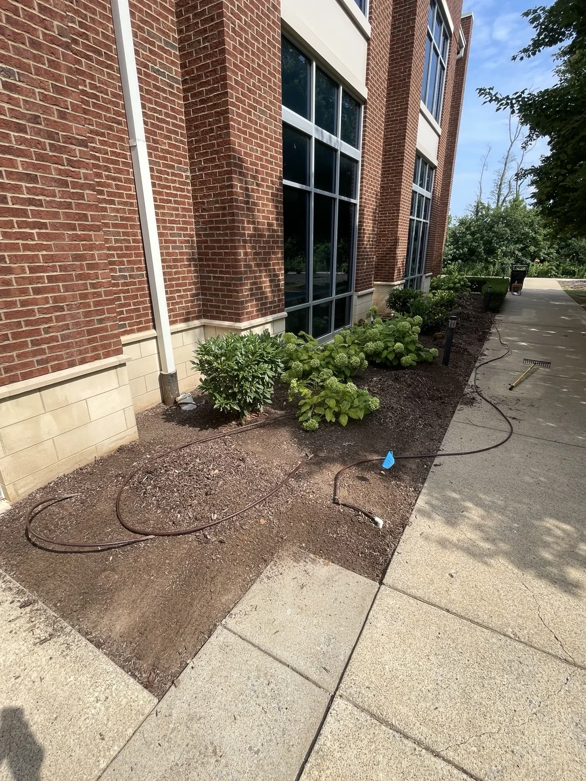 Commercial landscape bed before river rock installation